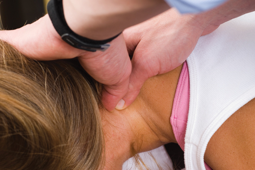 Woman recieving neck assessment