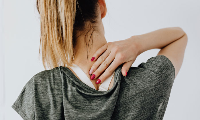Woman rubbing back of neck